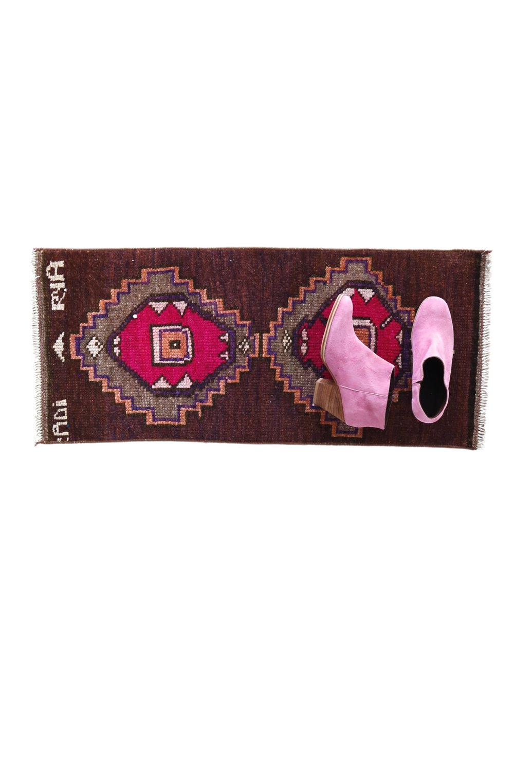 No. 1709 Mini Turkish Vintage Rug - 1'4" x 3'0" - Canary Lane
"Rectangular handwoven rug with a rich brown background, featuring two bold geometric medallions in magenta and orange tones, framed by intricate zigzag patterns and small decorative accents.