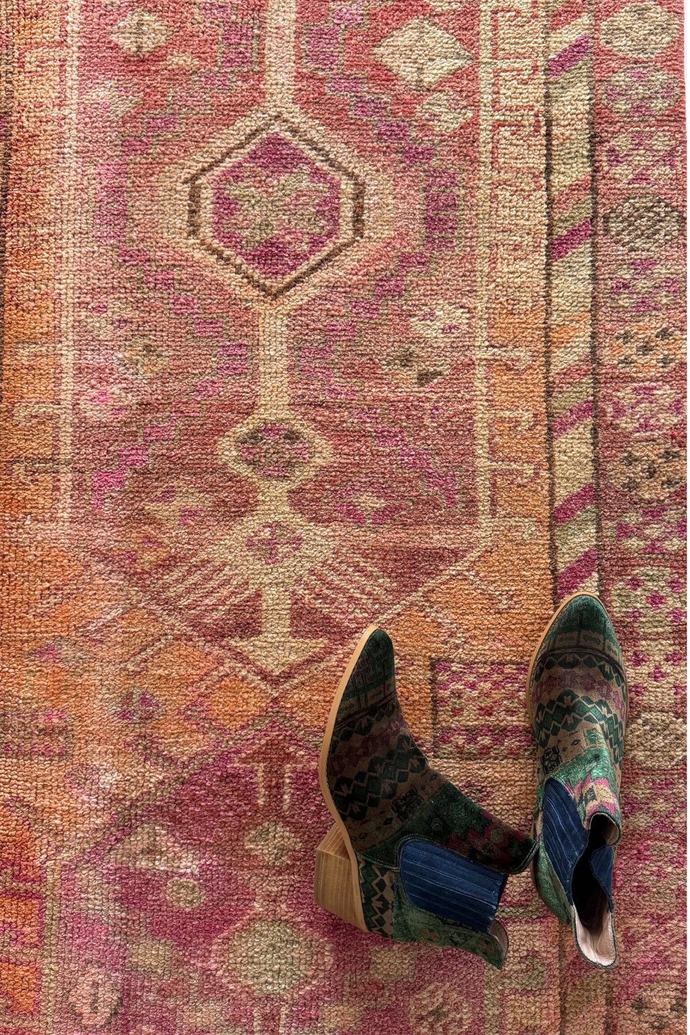 'Seaford' Vintage Turkish Runner - 2'8.5" x 11'1" - Canary Lane
Close up of a vintage handwoven Turkish runner featuring intricate patterns and rich textures. The design showcases traditional craftsmanship with bold geometric shapes and detailed motifs. The color palette includes faded peach, tan, cream, pink, red, and gray, creating a harmonious blend of warm and cool tones.